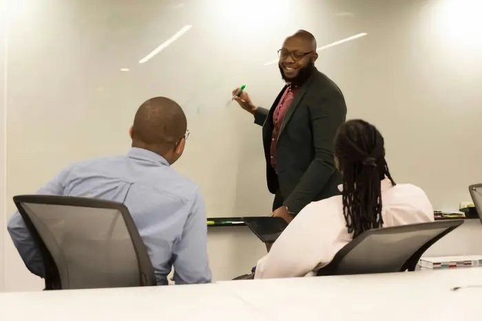 A leader presenting to a team around a meeting table